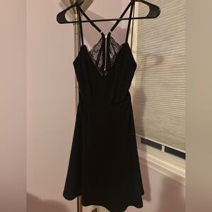 Like new, black mini dress with skater style skirt, open/lace back.